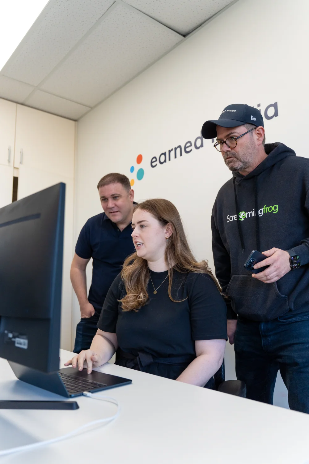 Strategists reviewing client work on a large screen